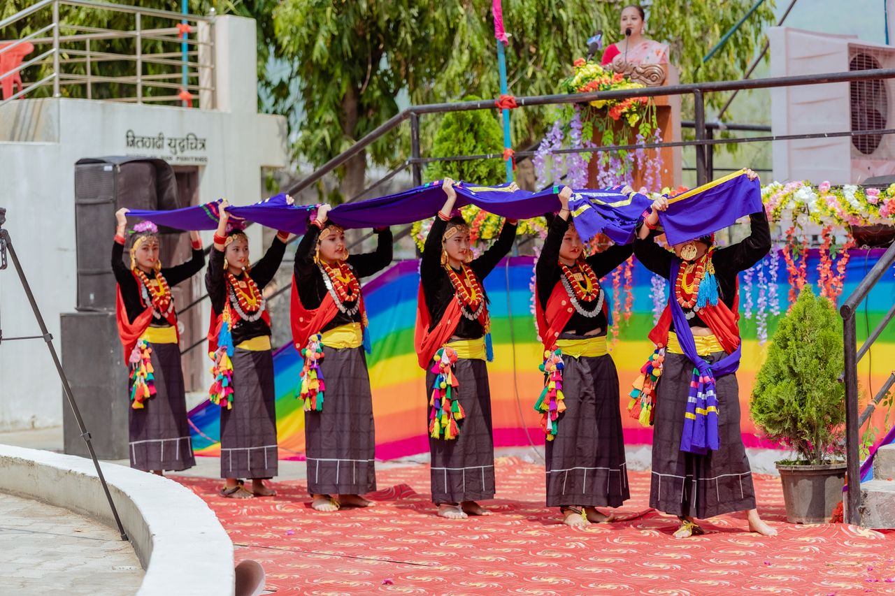 Cultural performance in Butwal, showcasing traditional Nepalese dance with colorful attire and scarves.